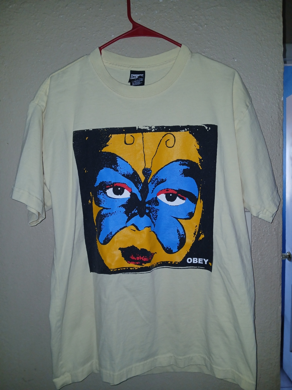 Obey Graphic Tee with Yellow & Blue Face Print